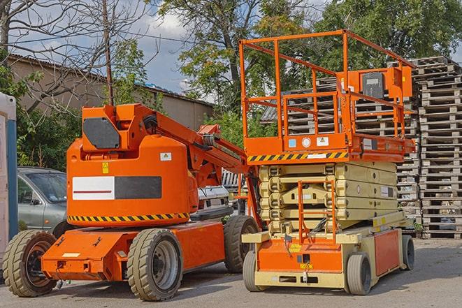 forklift carrying pallets in a busy warehouse in Carlstadt